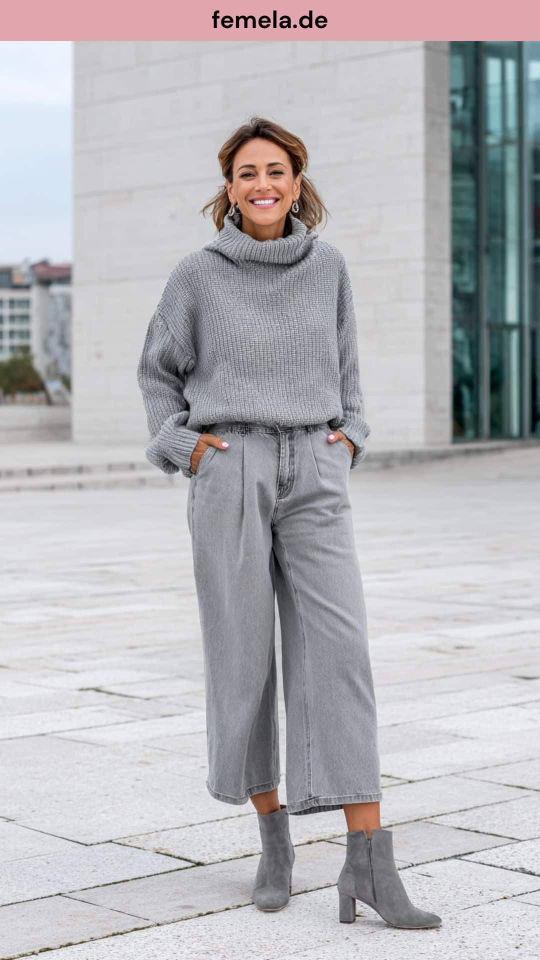 Ein komplett graues Outfit mit Wide-Leg Jeans und Kaschmirpullover in verschiedenen Graunuancen.
